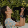 Caitlin McHugh Stamos wearing share the love St. Francis Peace Bracelets with her black lab puppy