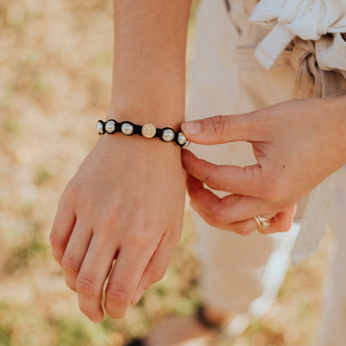 Divine Blessings Crystal Pearl and Benedictine Blessing Bracelet on a person's arm 