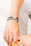 Family Virtues for Him and Strength Woven Cross Bracelets on man's wrist
