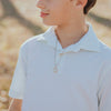 Young person in white shirt wearing a First Holy Communion St. Benedict Cross Necklace