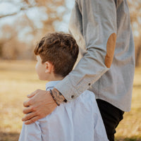 child with man wearing Godfather Morse Code Bracelet