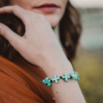 Grounded in Faith Bracelet - Blue Organic Crosses on a woman's wrist
