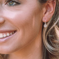 Young woman wearing Joy Earrings in silver 