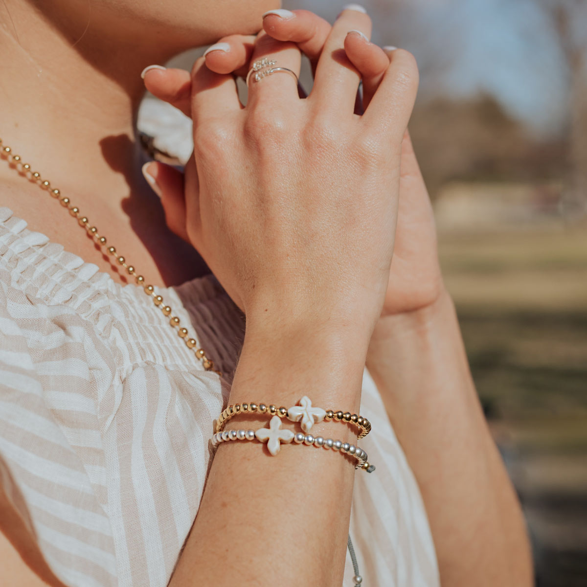 Living Lent Blessing Bracelets on woman with her hands clasped praying