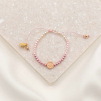 Love Lights the Way pink ombre and rose gold tone bracelet for kids on granite slab