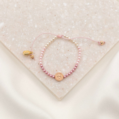 Love Lights the Way pink ombre and rose gold tone bracelet for kids on granite slab