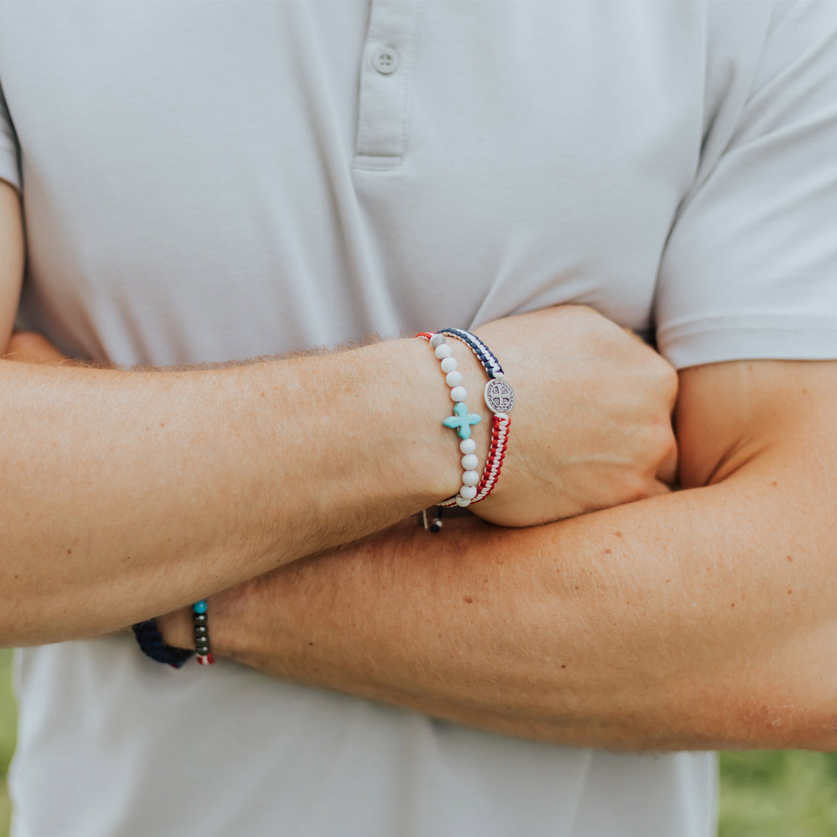 Close up of Man wearing a United in Prayer Gemstone and a Unity Woven Red White and Blue Bracelet