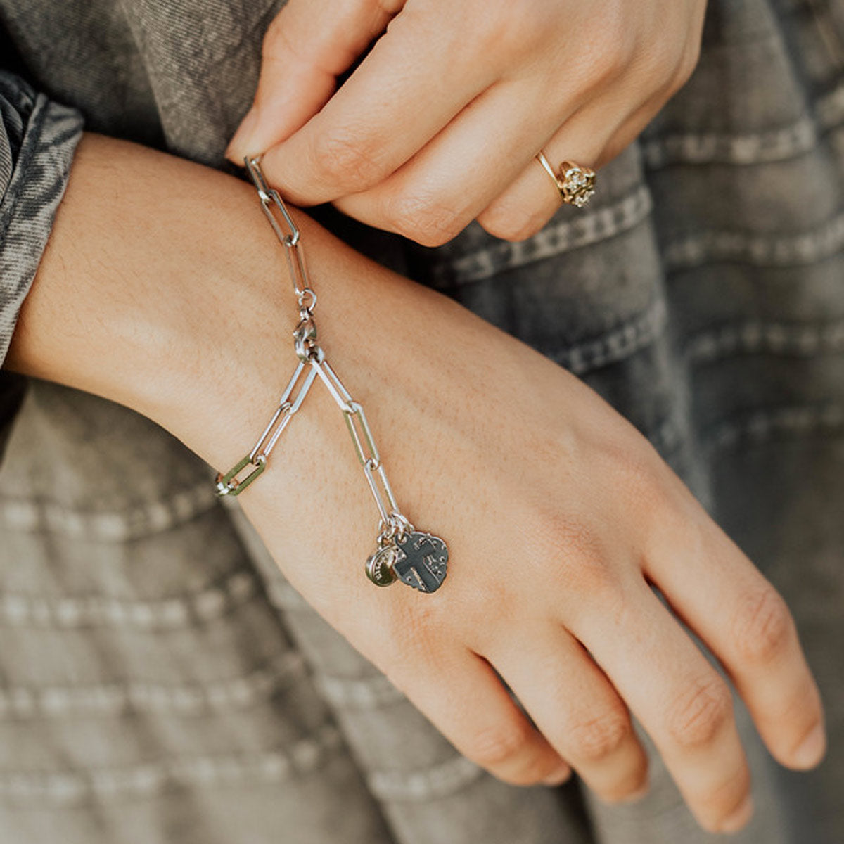 Renewal Consecration Bracelet worn on wrist paper clip style chain in silver tone