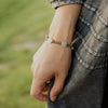 Stellar Blessings Light of Dawn Blessing Bracelet on a woman's wrist in a close up photo